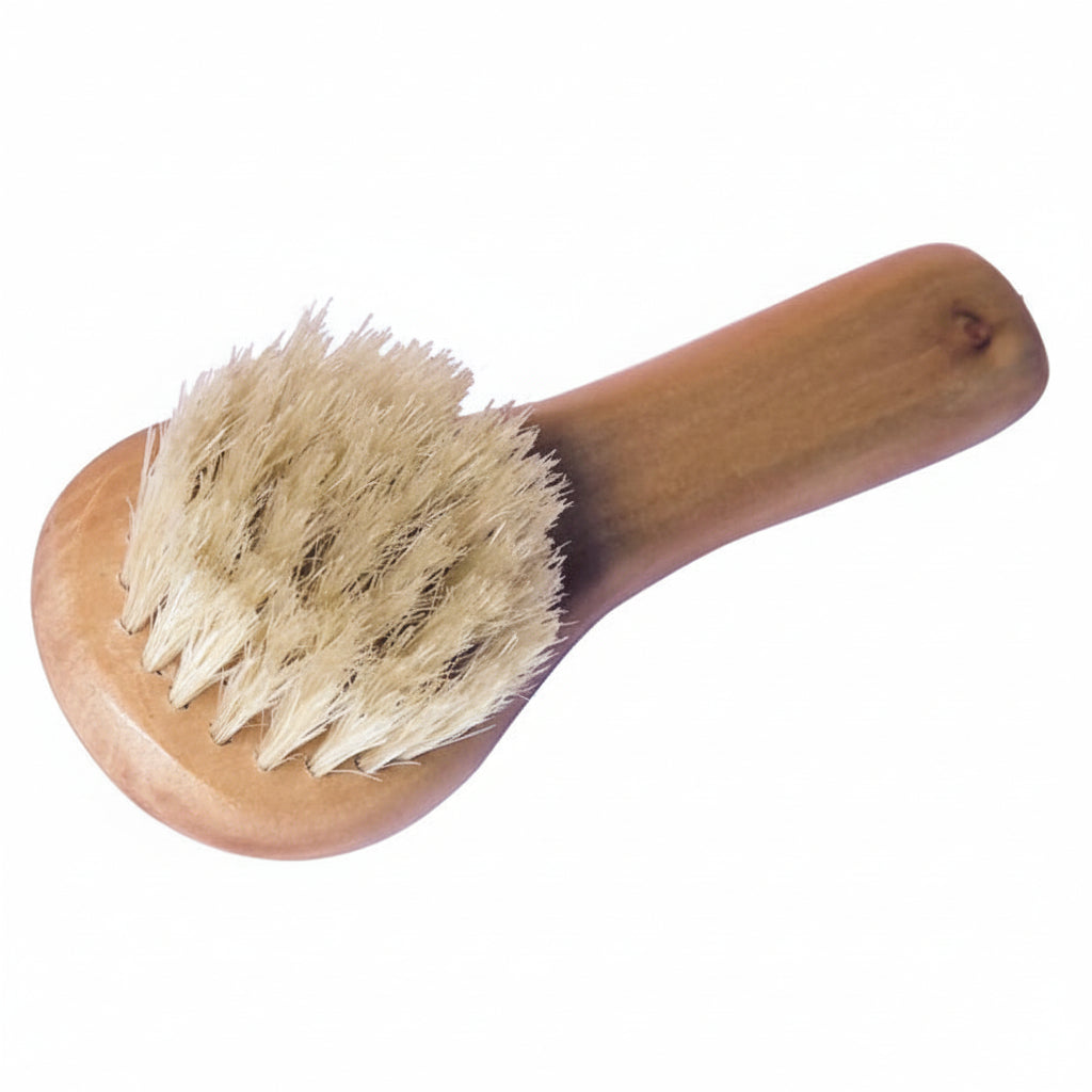 Close-up of Croll and Denecke Wooden handles facial cleansing brush with natural bristles on a white background