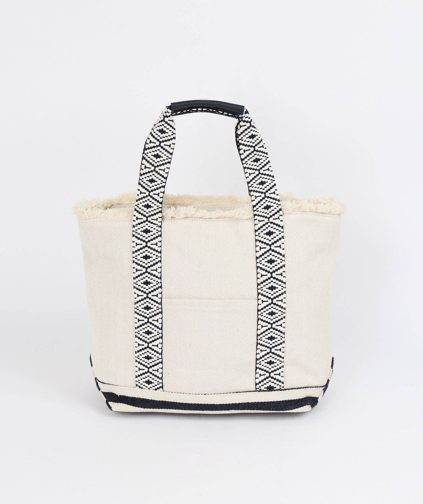 Front view of Off White canvas tote bag by Pia Rossini with black geometric pattern on handles against a white background