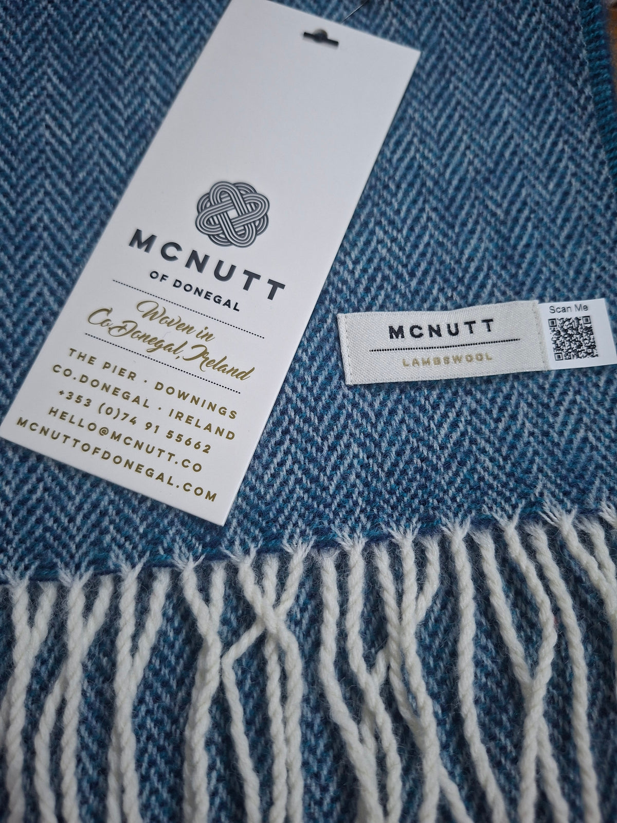 McNutt Landscape blue Herringbone Lambswool Scarf, showing blue herringbone woven pattern and grey fringed edge