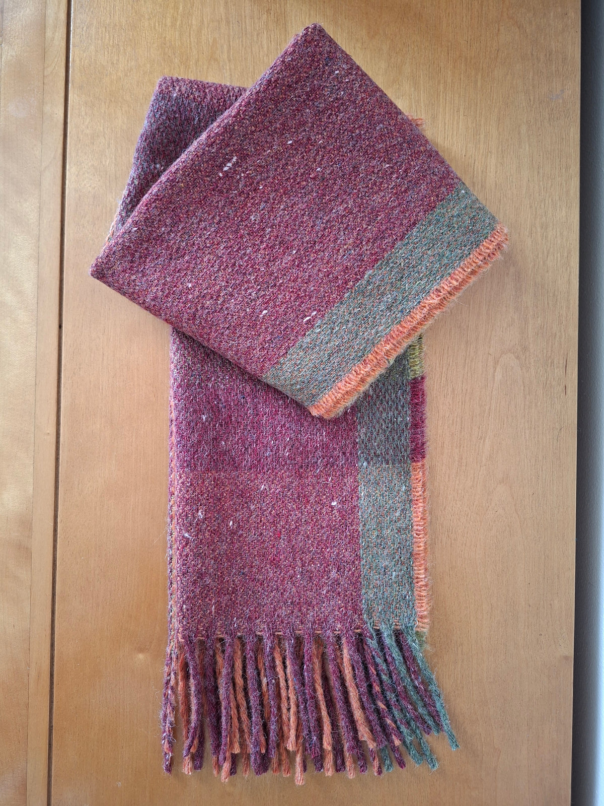McNutt FOREVER recycled Merino wool Harvest scarf in red, orange and green check.