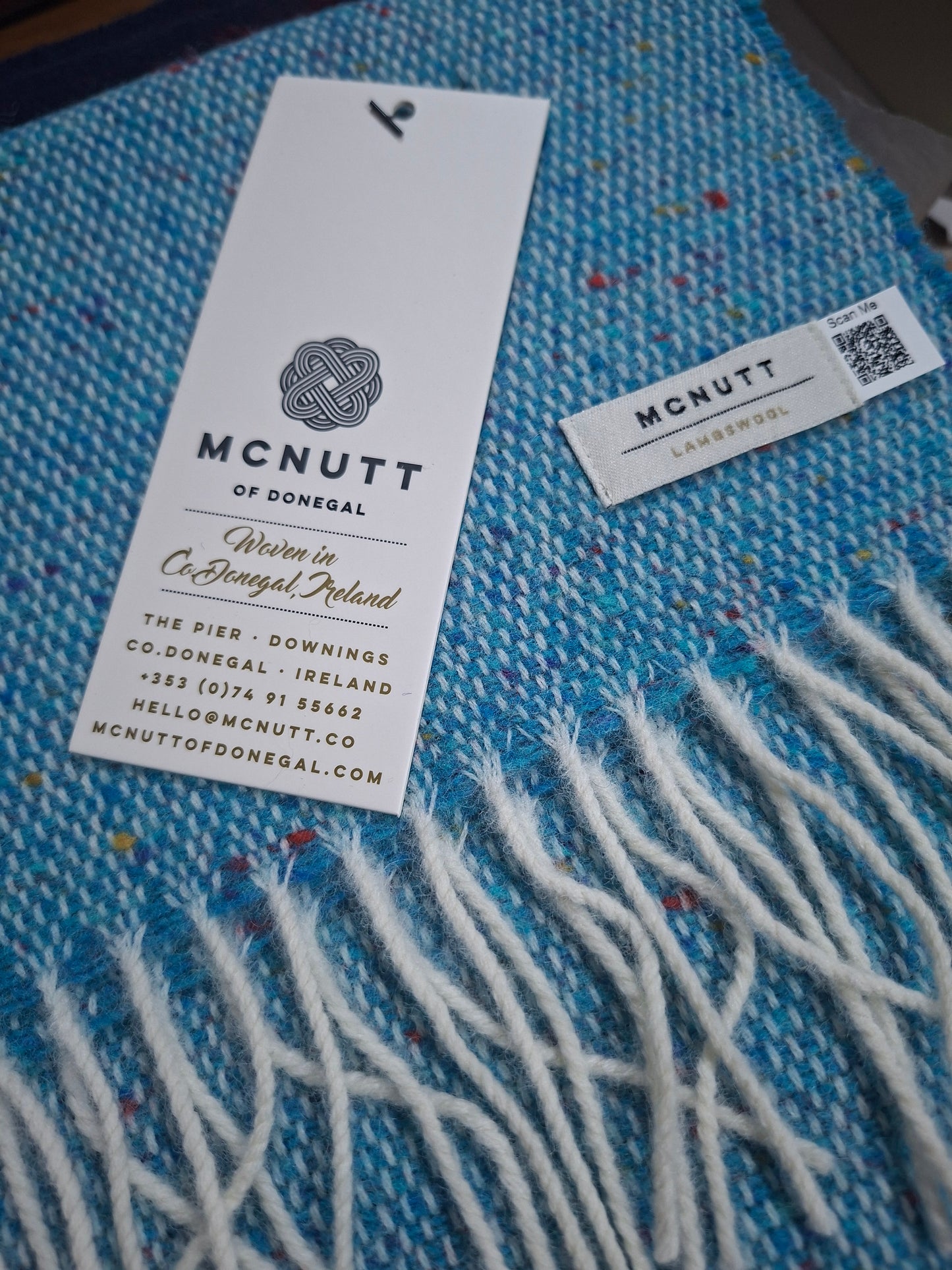 McNutt Spotted Teal Merino Lambswool Scarf, showing teal fabric, contrasting spots and fringed edge
