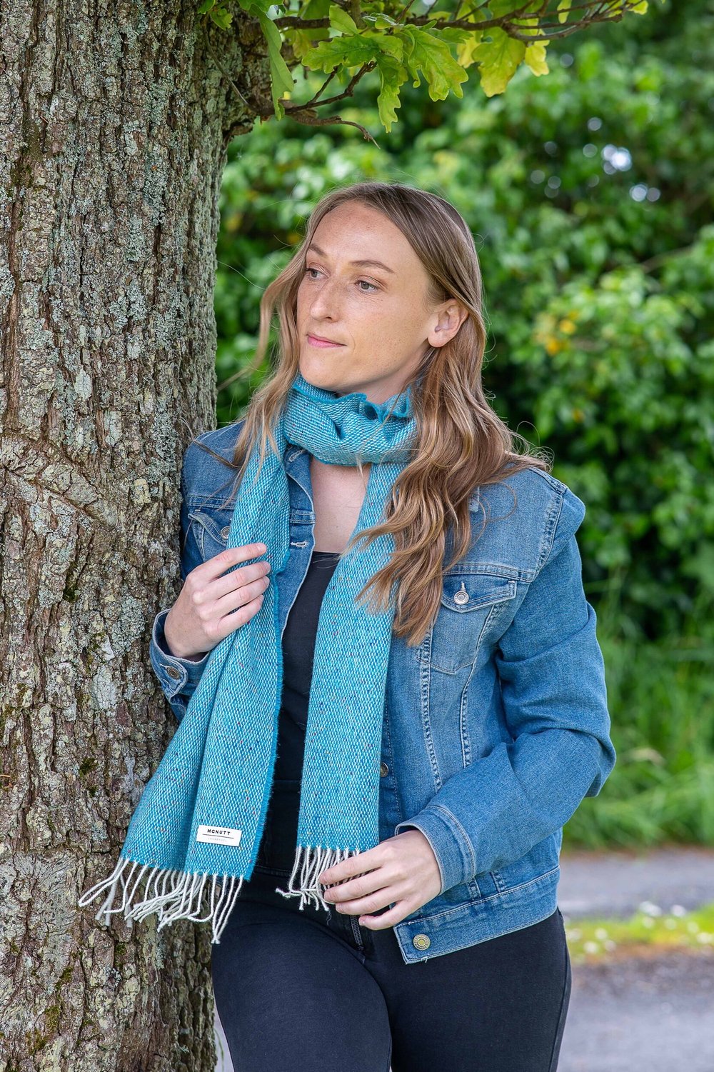 Lady wearing McNutt Donegal lambswool tweed scarf in Peacock