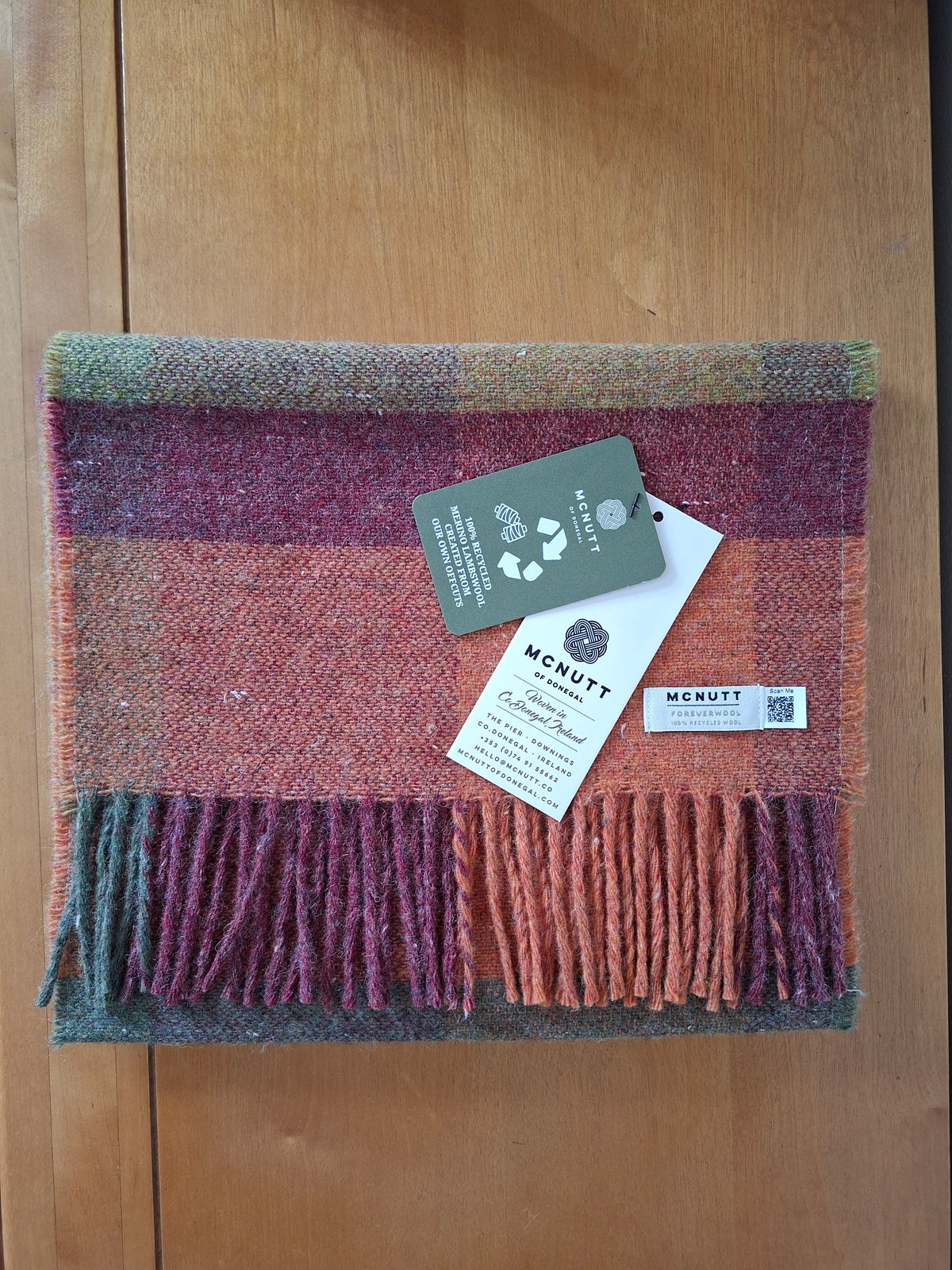 McNutt FOREVER recycled Merino wool Harvest Scarf in red, orange and green check.